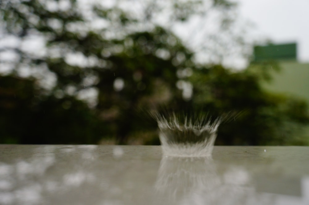 a glass of water sitting on top of a table