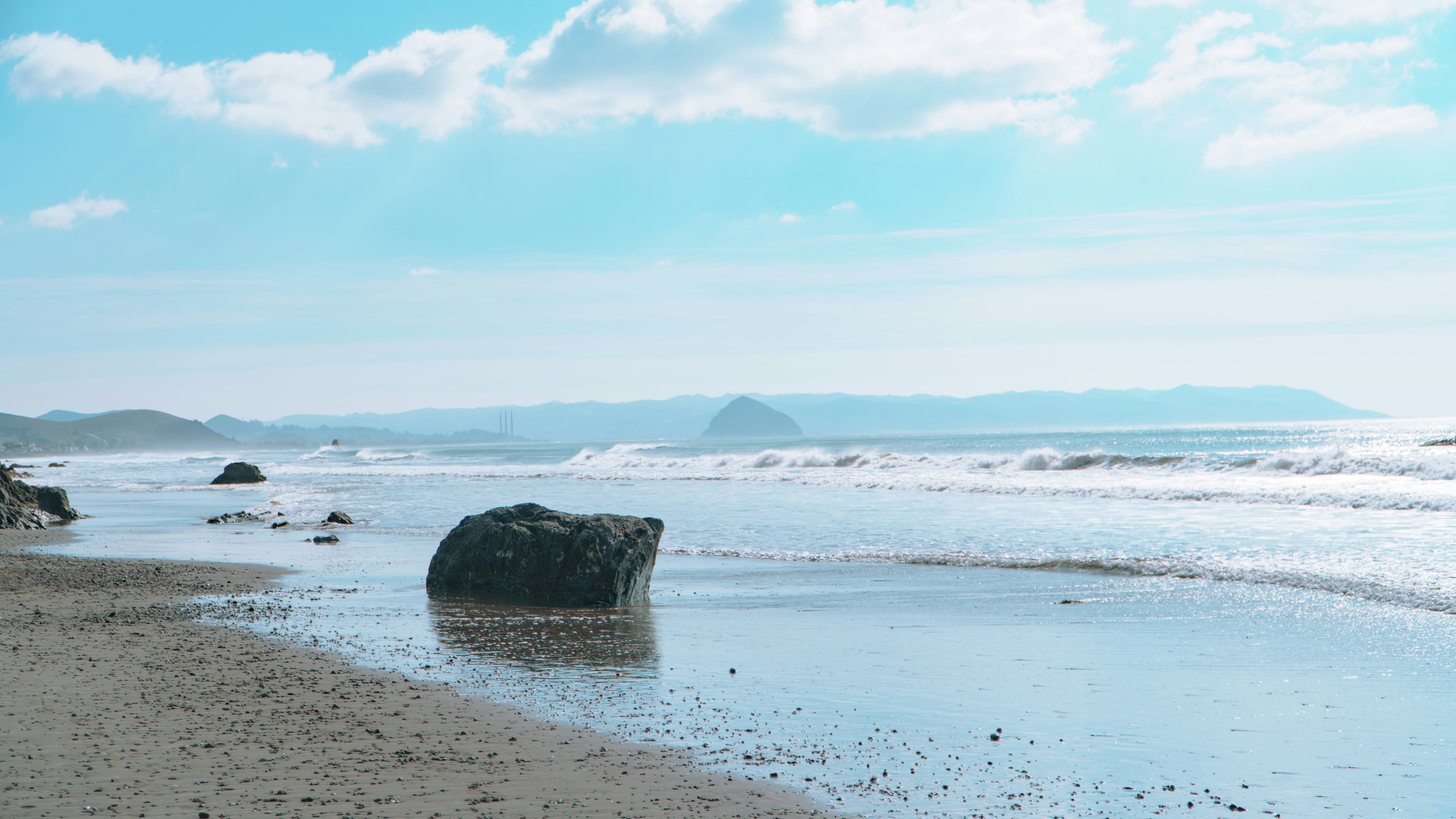 A large rock sitting on top of a sandy beach photo – Free Blue Image on ...