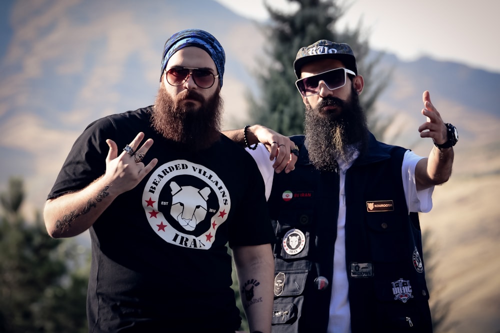 two bearded men standing next to each other