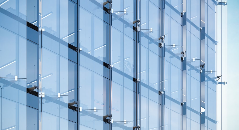 a tall glass building with a sky background