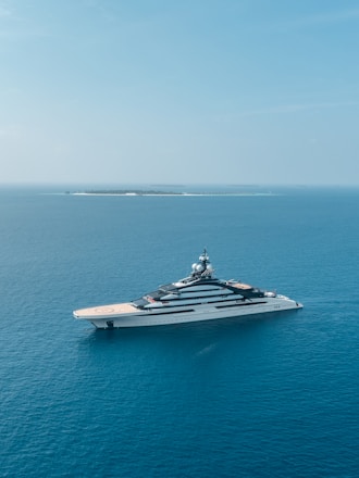 A luxurious yacht sailing in clear blue waters.