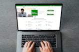 a person typing on a laptop with their hands