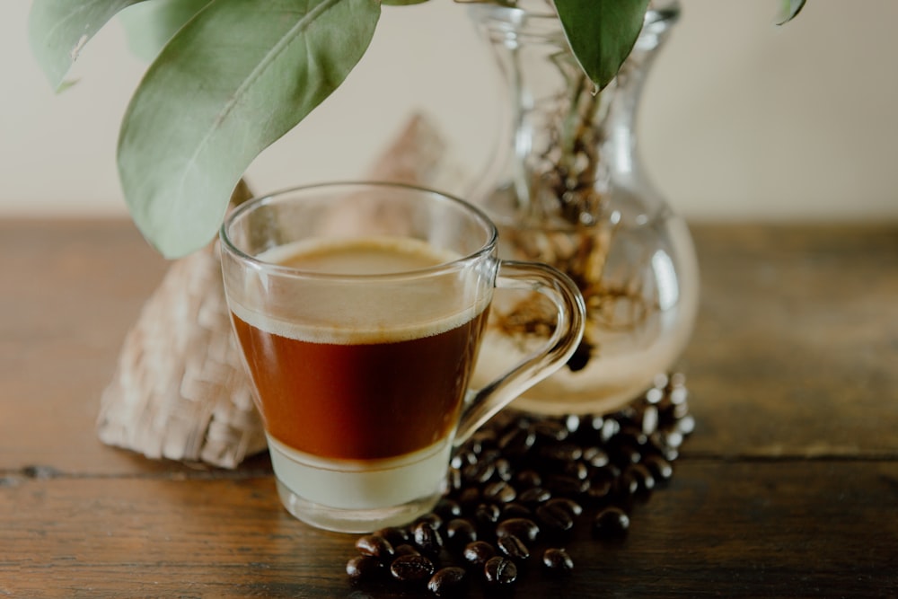 a cup of coffee sitting on top of a wooden table