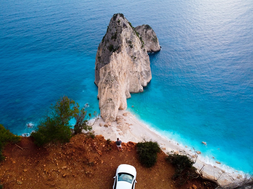an aerial view of a car parked on the beach