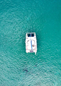 a small boat floating on top of a body of water