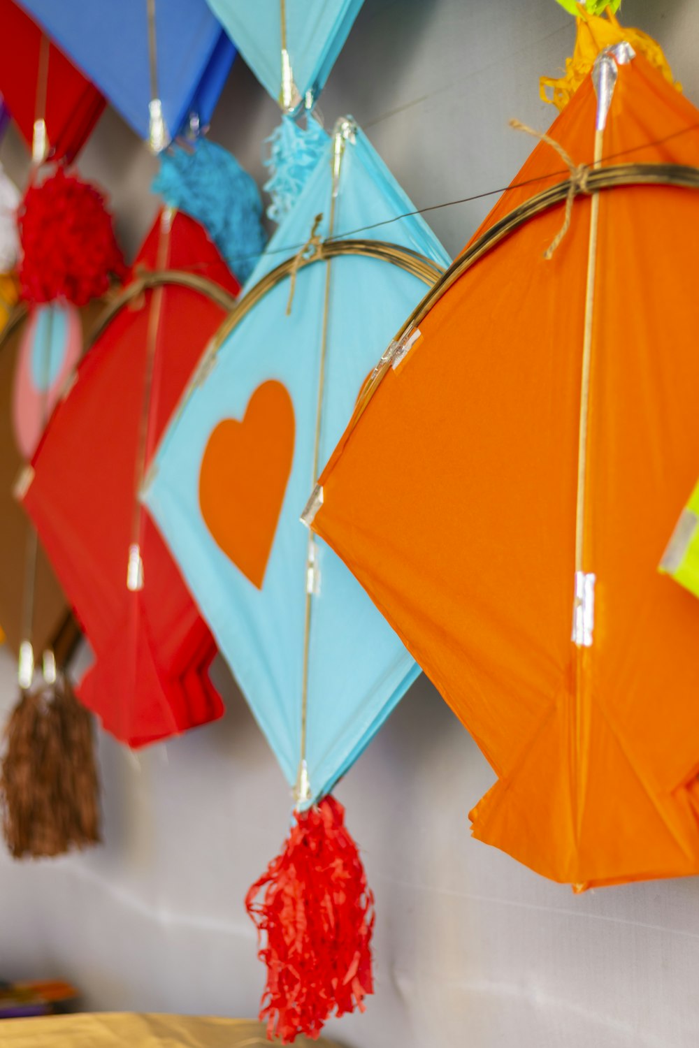 a group of colorful kites hanging from a wall