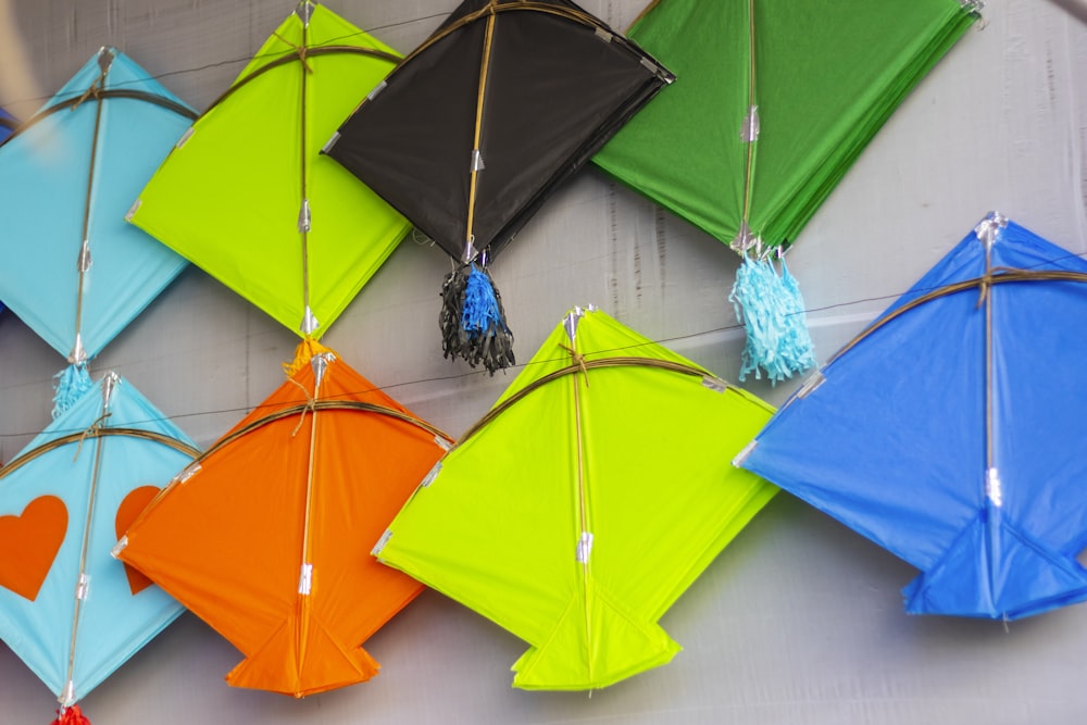 a group of colorful kites hanging on a wall