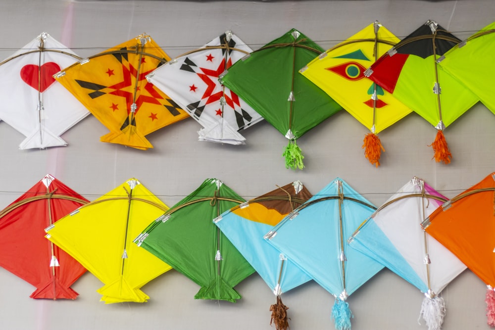 a group of colorful kites hanging on a wall