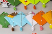 a group of colorful kites hanging on a wall