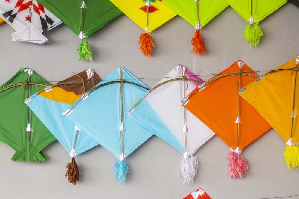 a group of colorful kites hanging on a wall