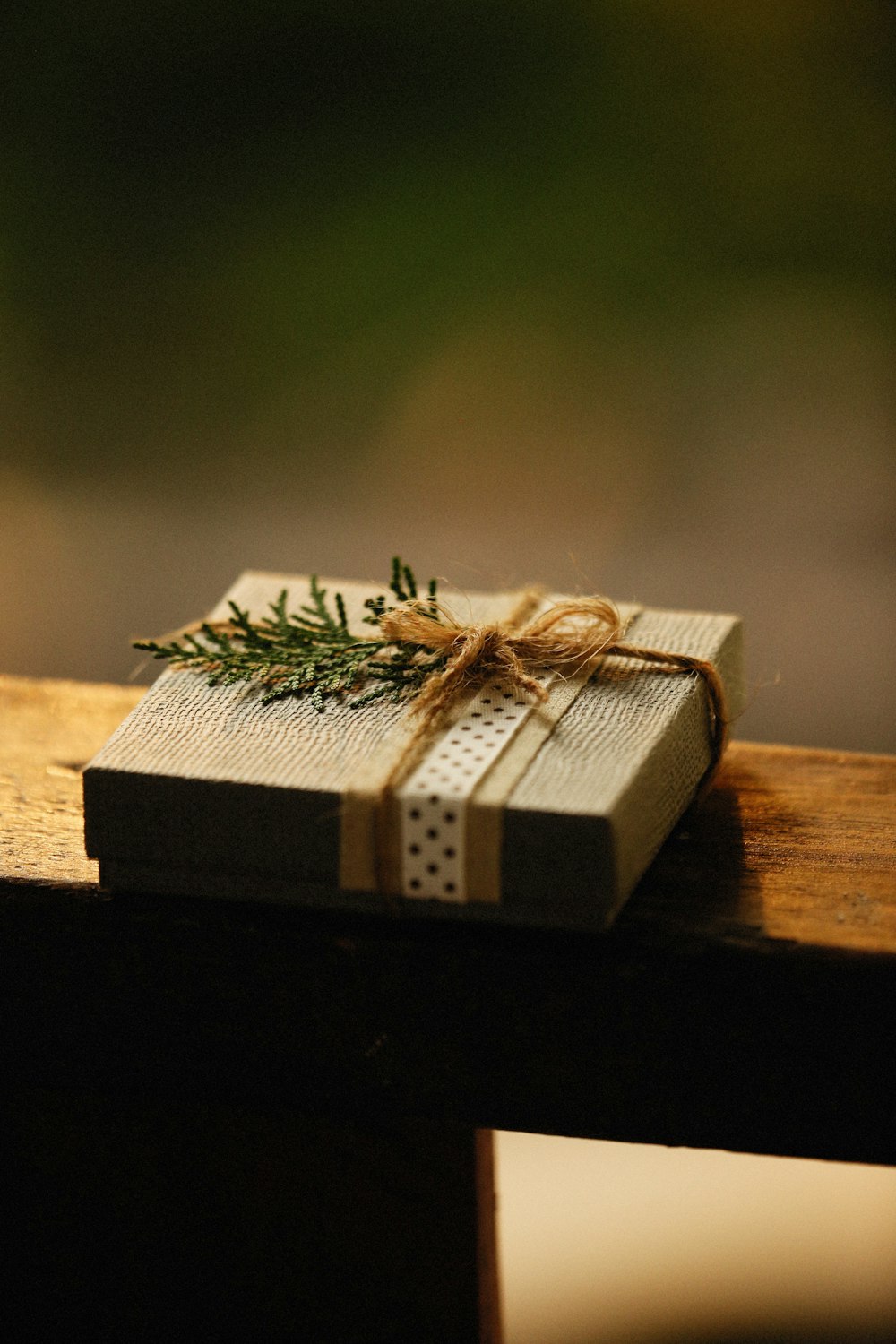 a wrapped present sitting on top of a wooden table