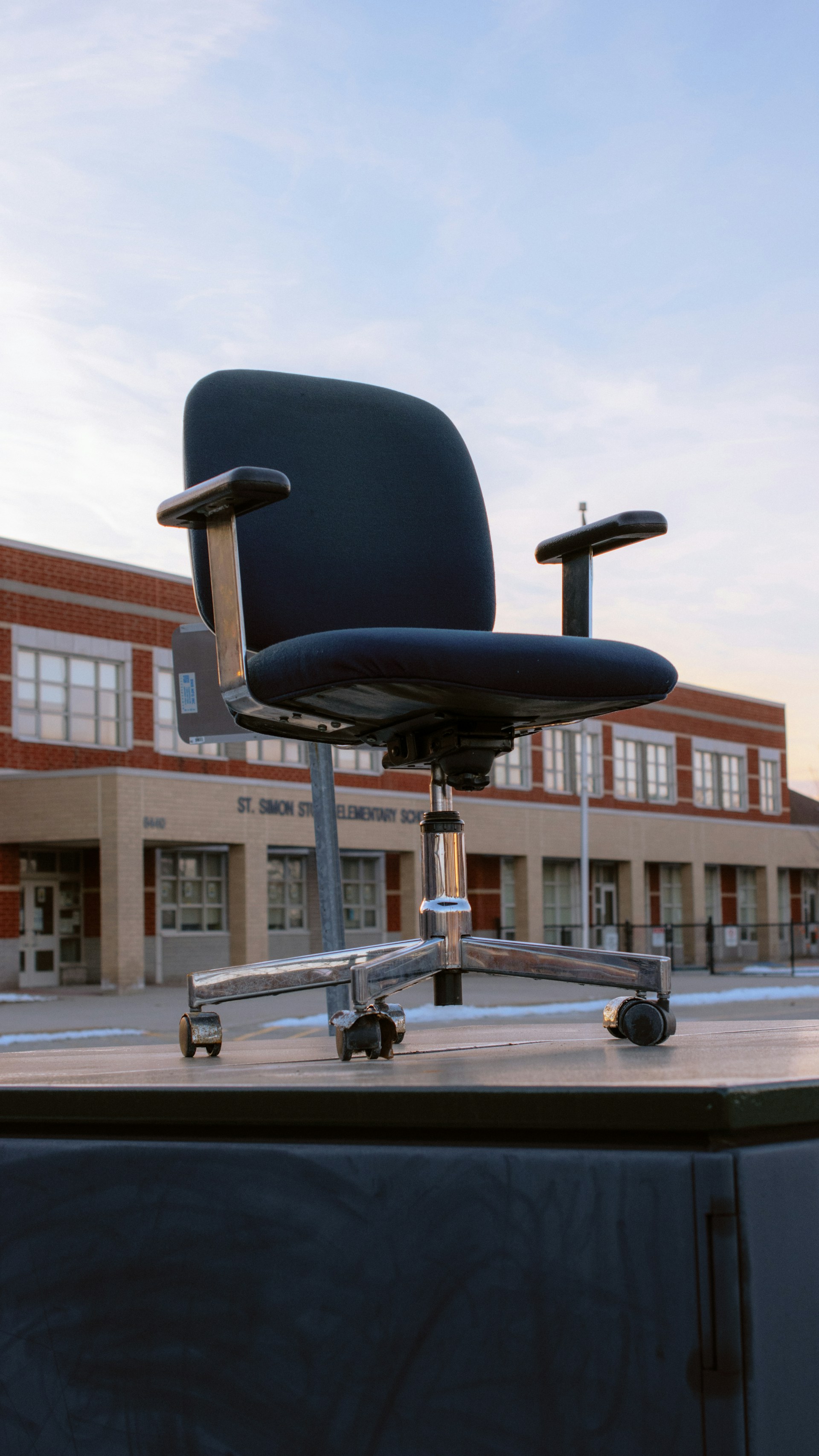 an office chair sitting on top of a wooden table