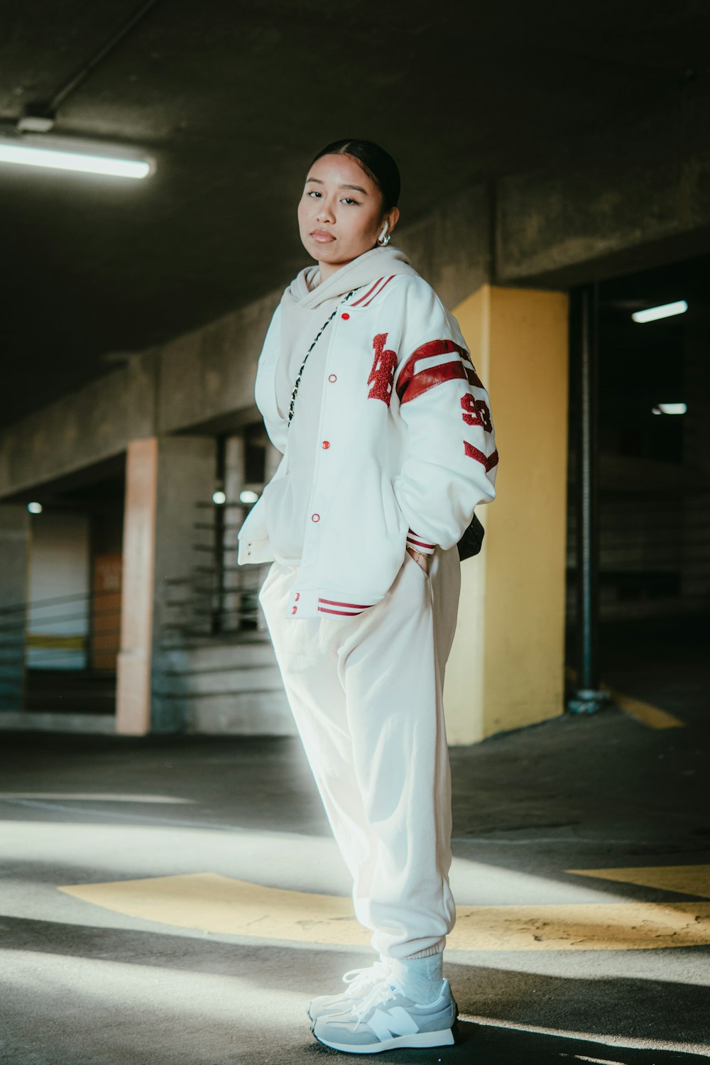 a woman in a white jacket and white pants