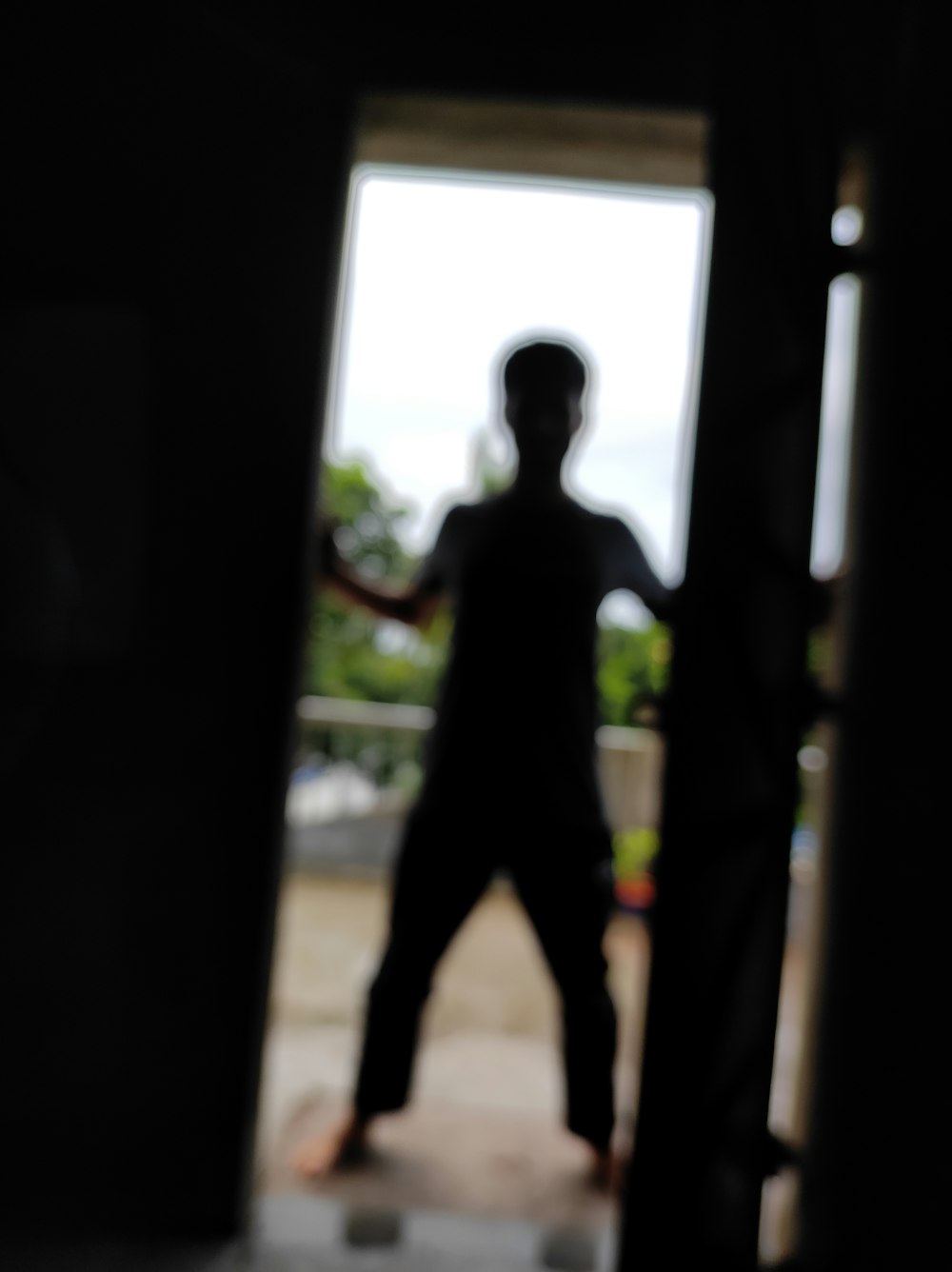 a silhouette of a person standing in a doorway