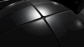 Close-up of a sleek white aluminum board with a smooth surface and subtle reflections.