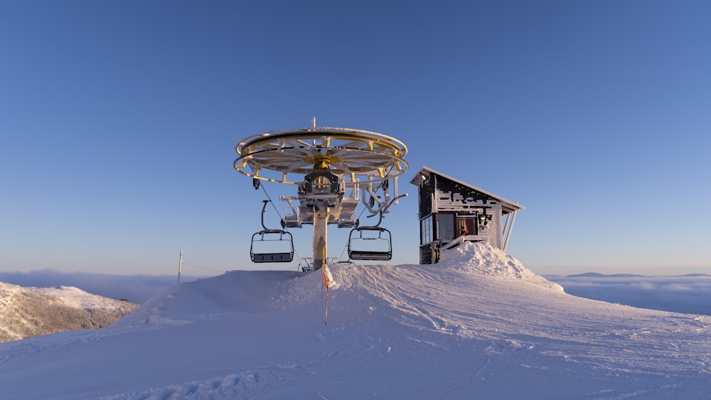 a ski lift sitting on top of a snow covered slope