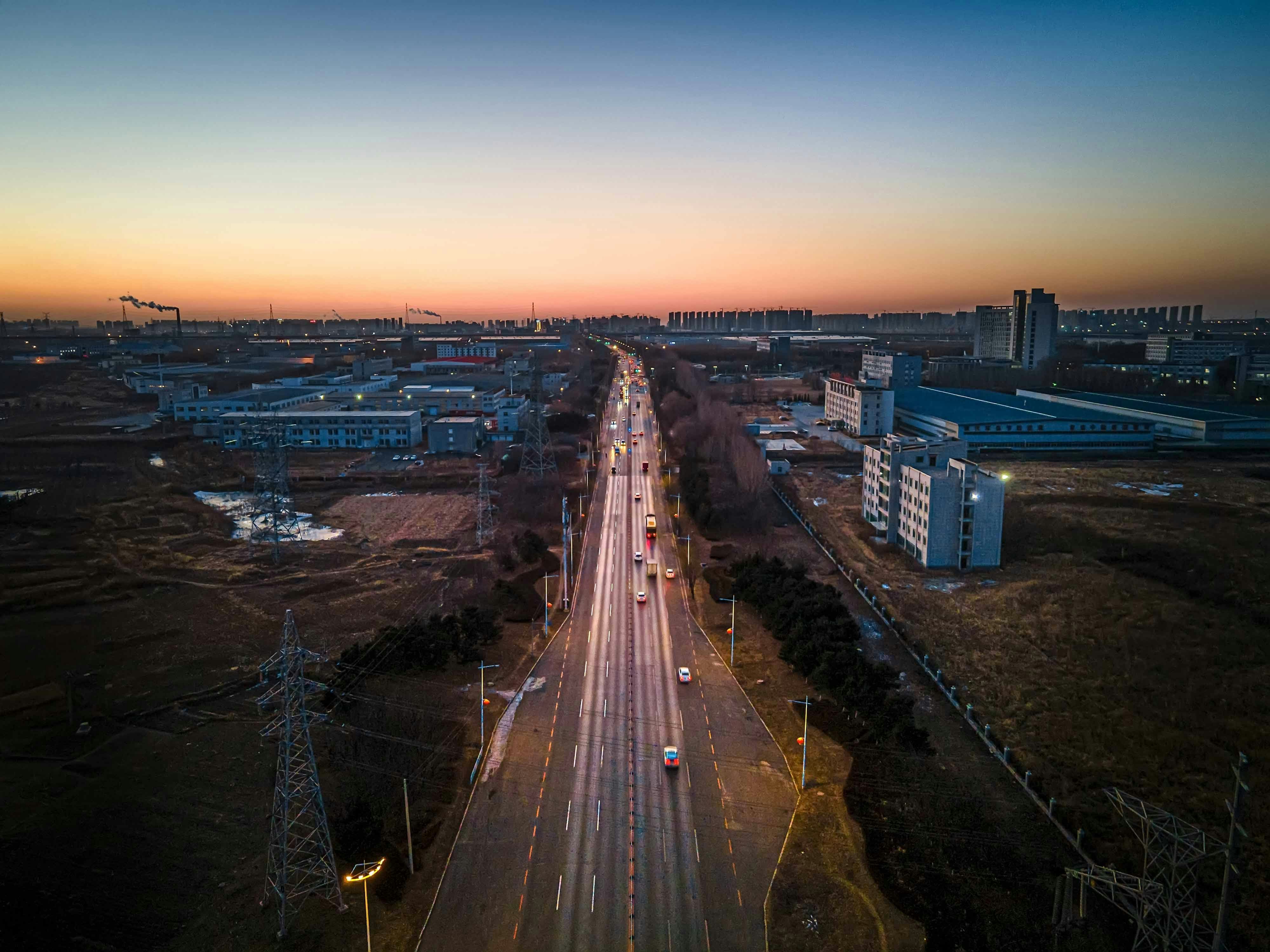 an aerial view of a city street at sunset