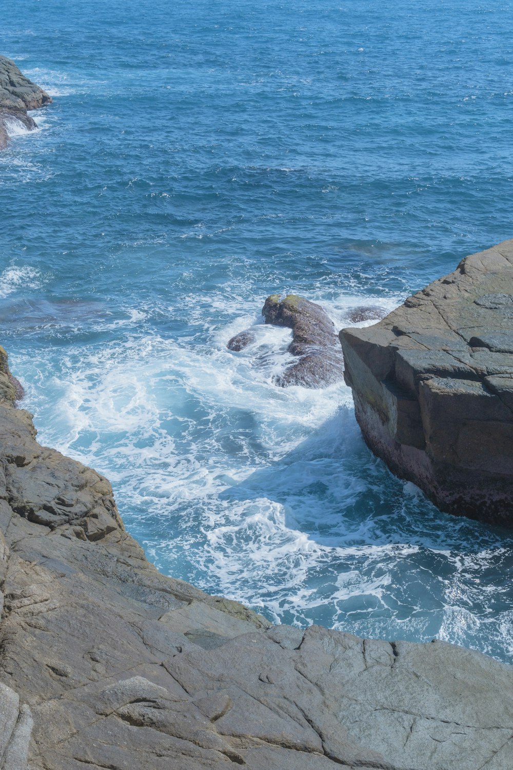 a large rock outcropping next to a body of water