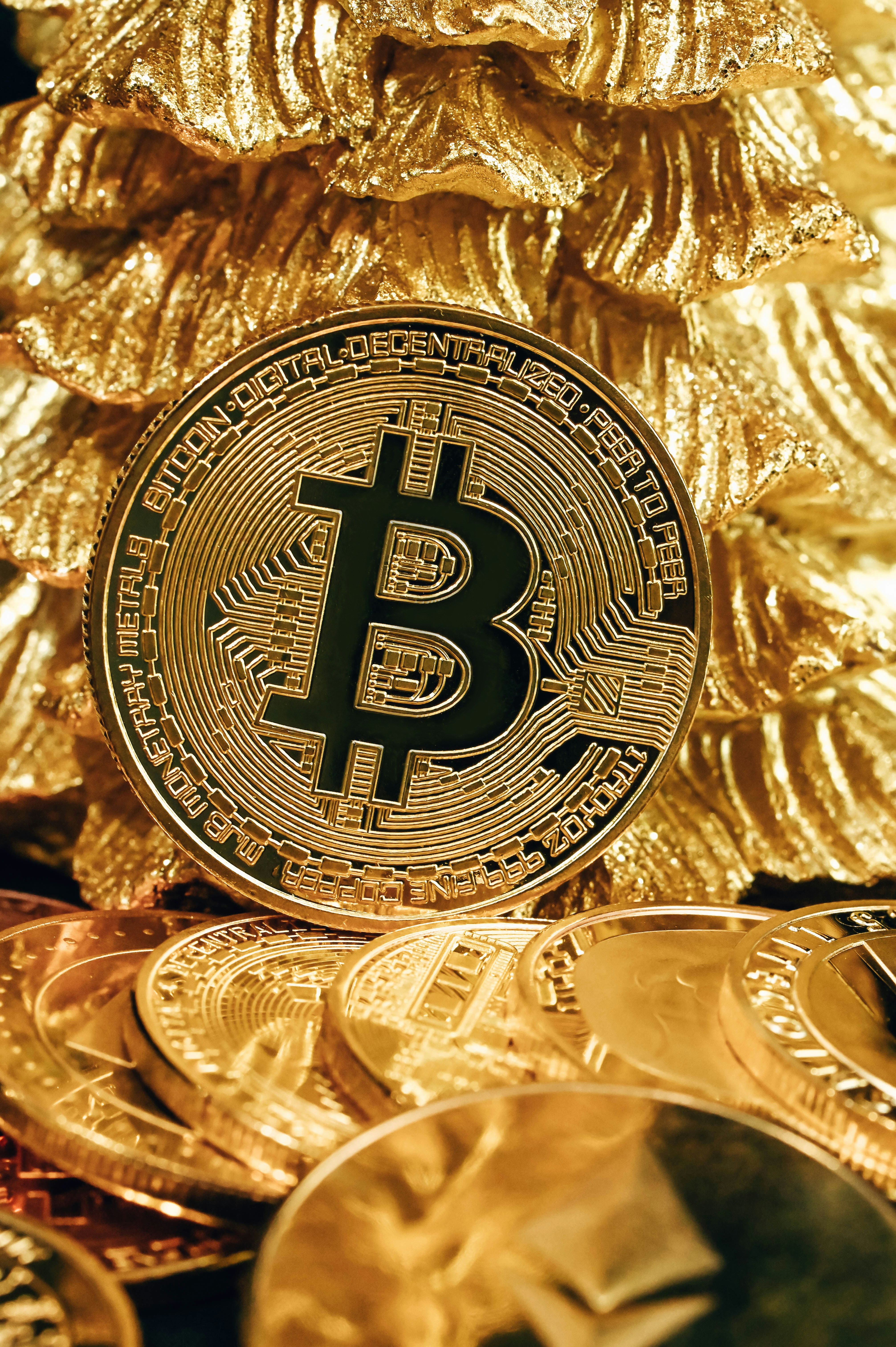 A Bitcoin leaning on a gold pine tree