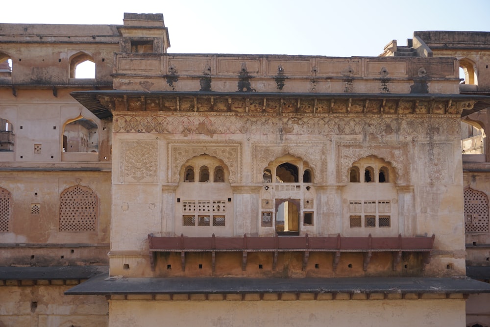 an old building with a clock on the front of it