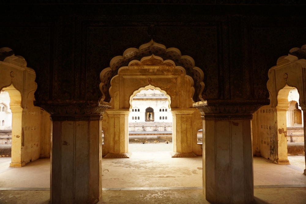 an archway in a building with columns and arches