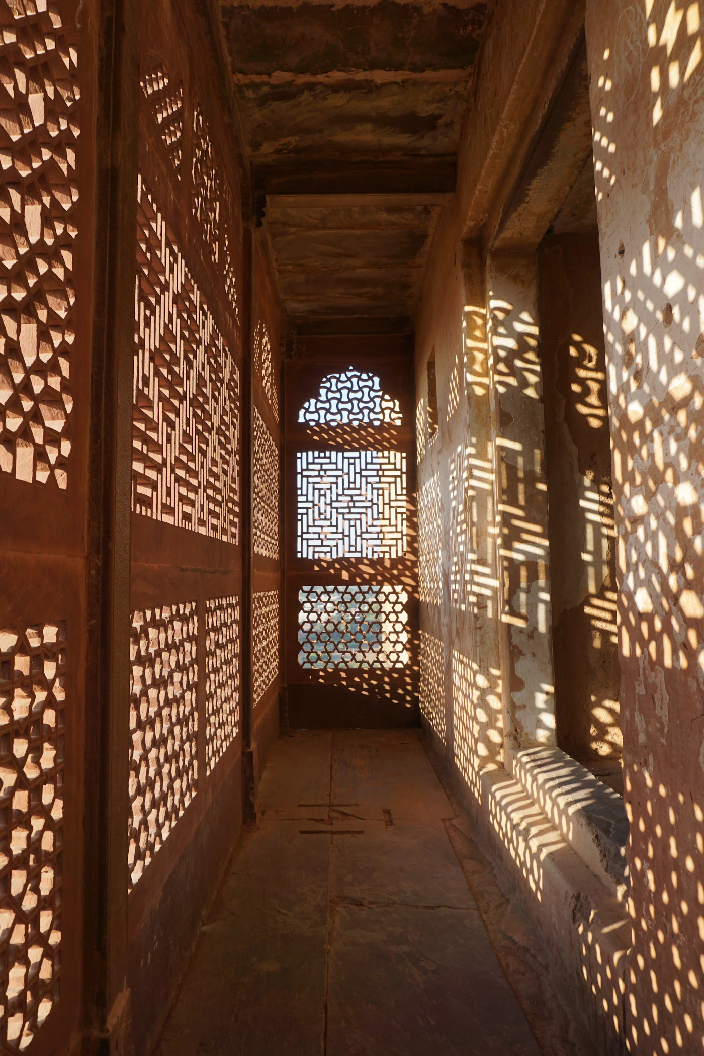 Carved jaali screens with soft light for pooja room