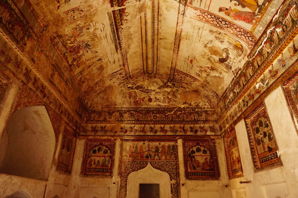 a room with paintings on the walls and ceiling