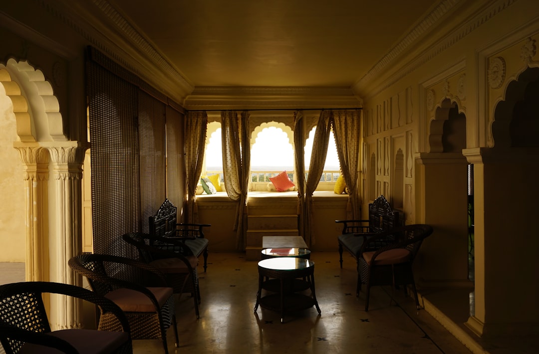a dimly lit room with chairs and tables,