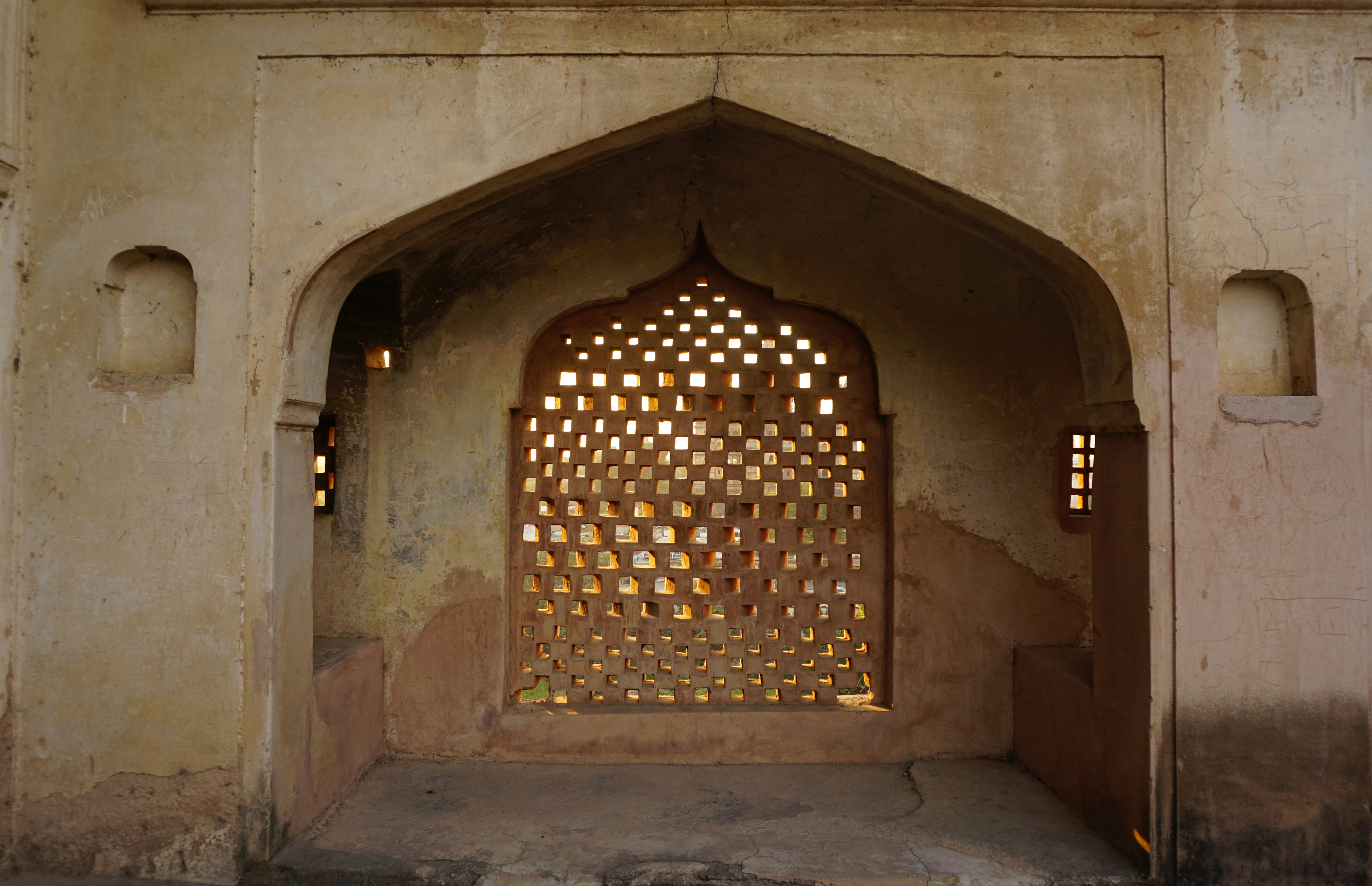 a stone arch with a window in the middle of it