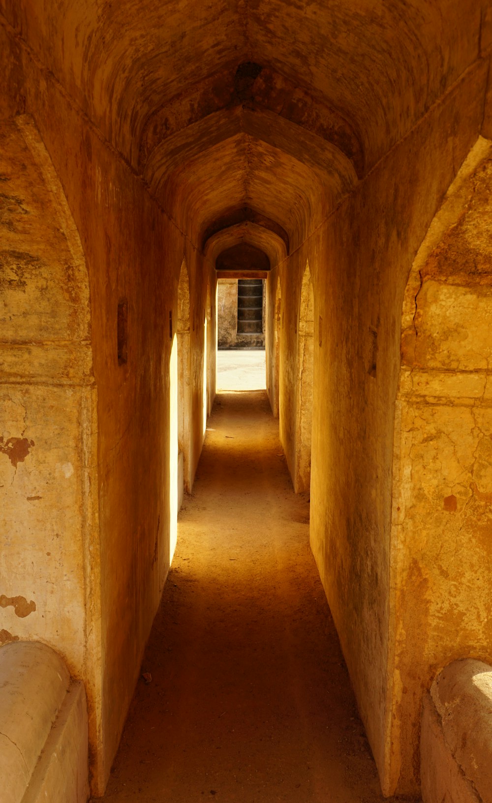 a long tunnel with a bench in the middle of it