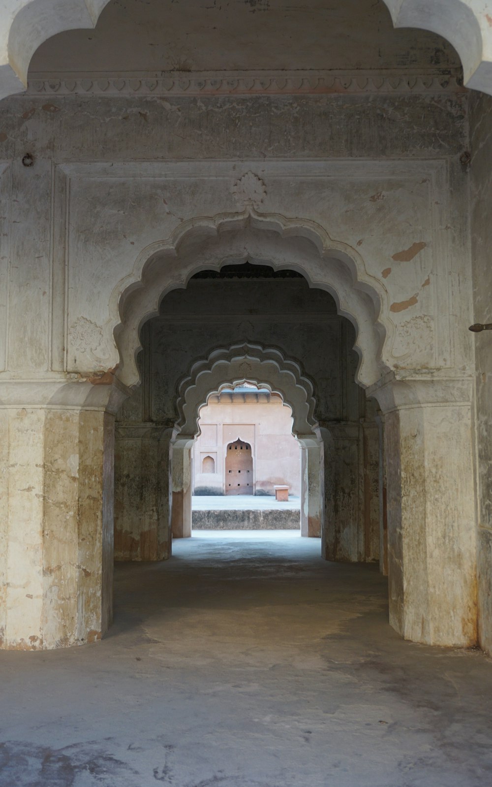 an archway in a building with a clock on the wall