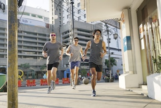a group of young men running down a street