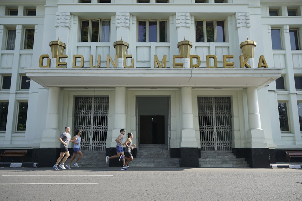 a group of people that are walking in front of a building