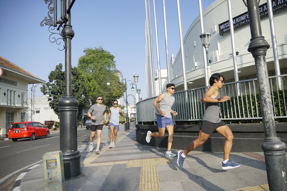 a group of people running on a city street