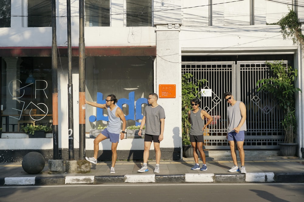 a group of people standing on the side of a road