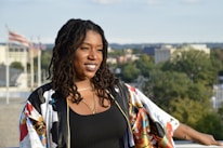 a woman standing on top of a roof