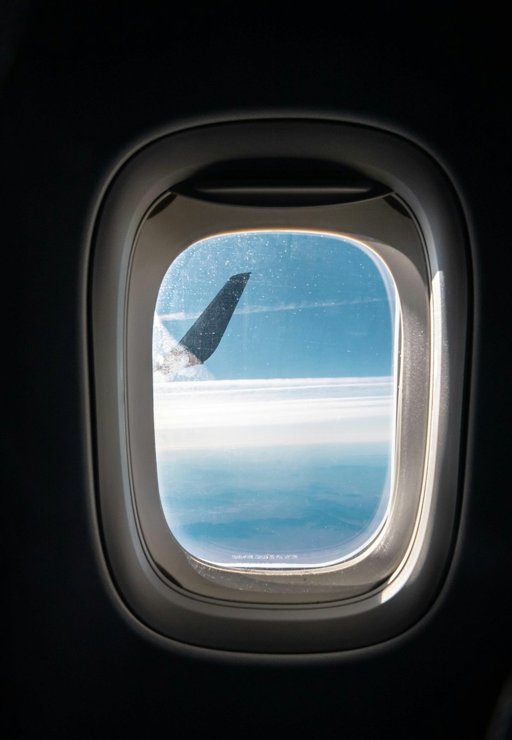 a view of the wing of an airplane through a window