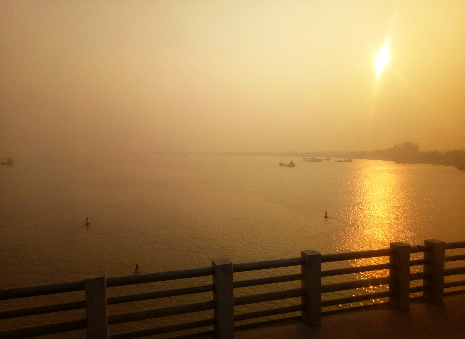 the sun is setting over a body of water