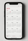 a phone with a calendar on the screen