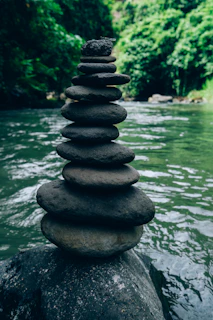 a stack of rocks sitting on top of a river