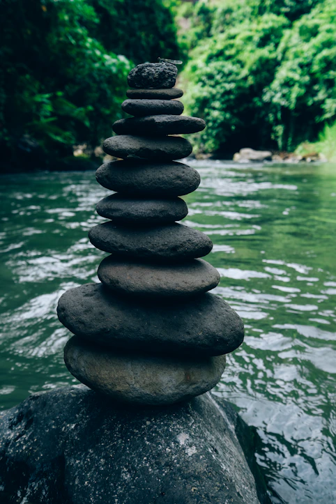 a stack of rocks sitting on top of a river
