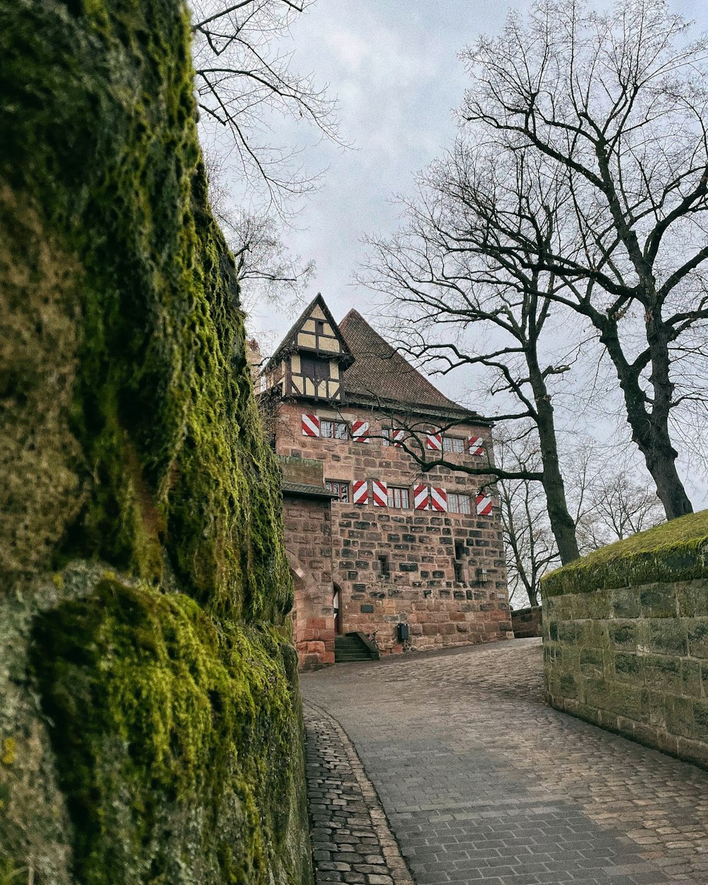 a brick building with moss growing on the side of it