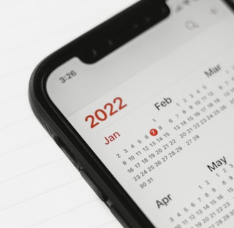 a cell phone with a calendar on the screen