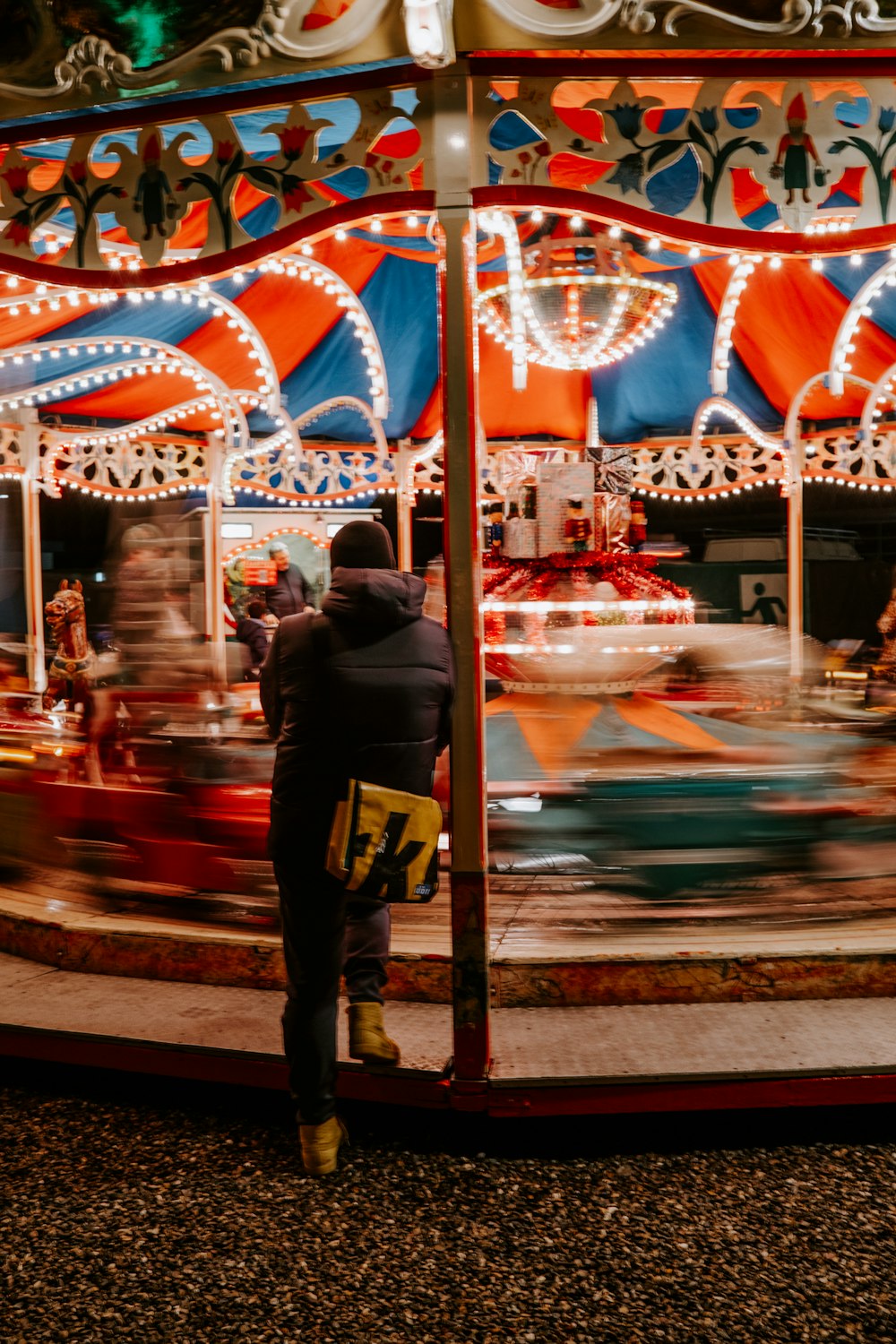 a person standing in front of a carnival ride