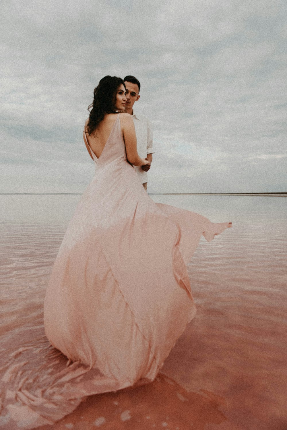 a man and a woman standing in the water