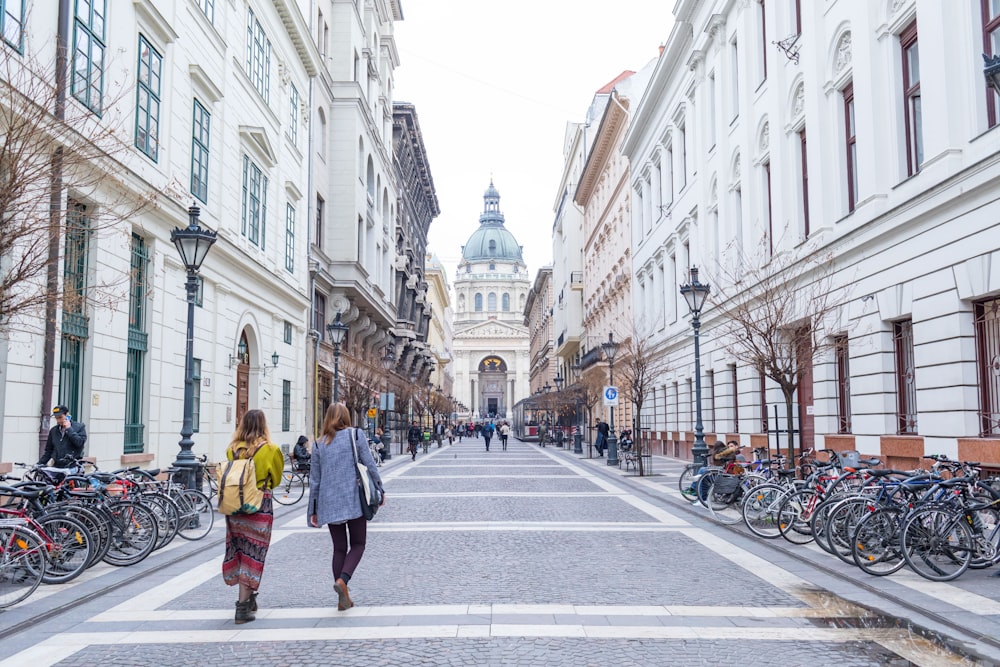 a couple of people walking down a street