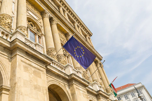 a european flag flying in front of a building