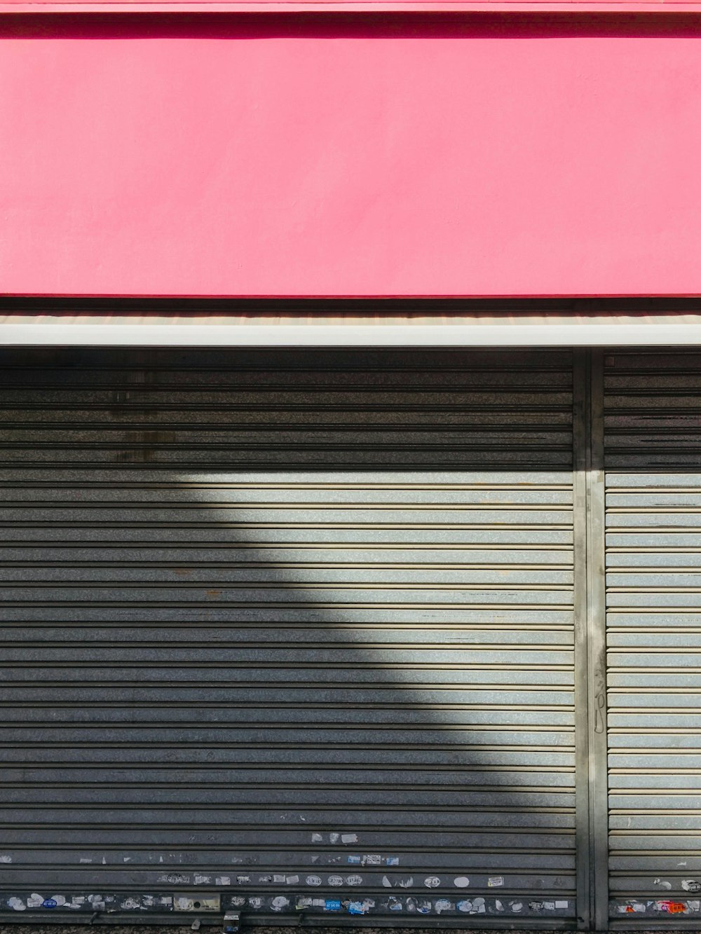 a bench sitting in front of a closed garage door