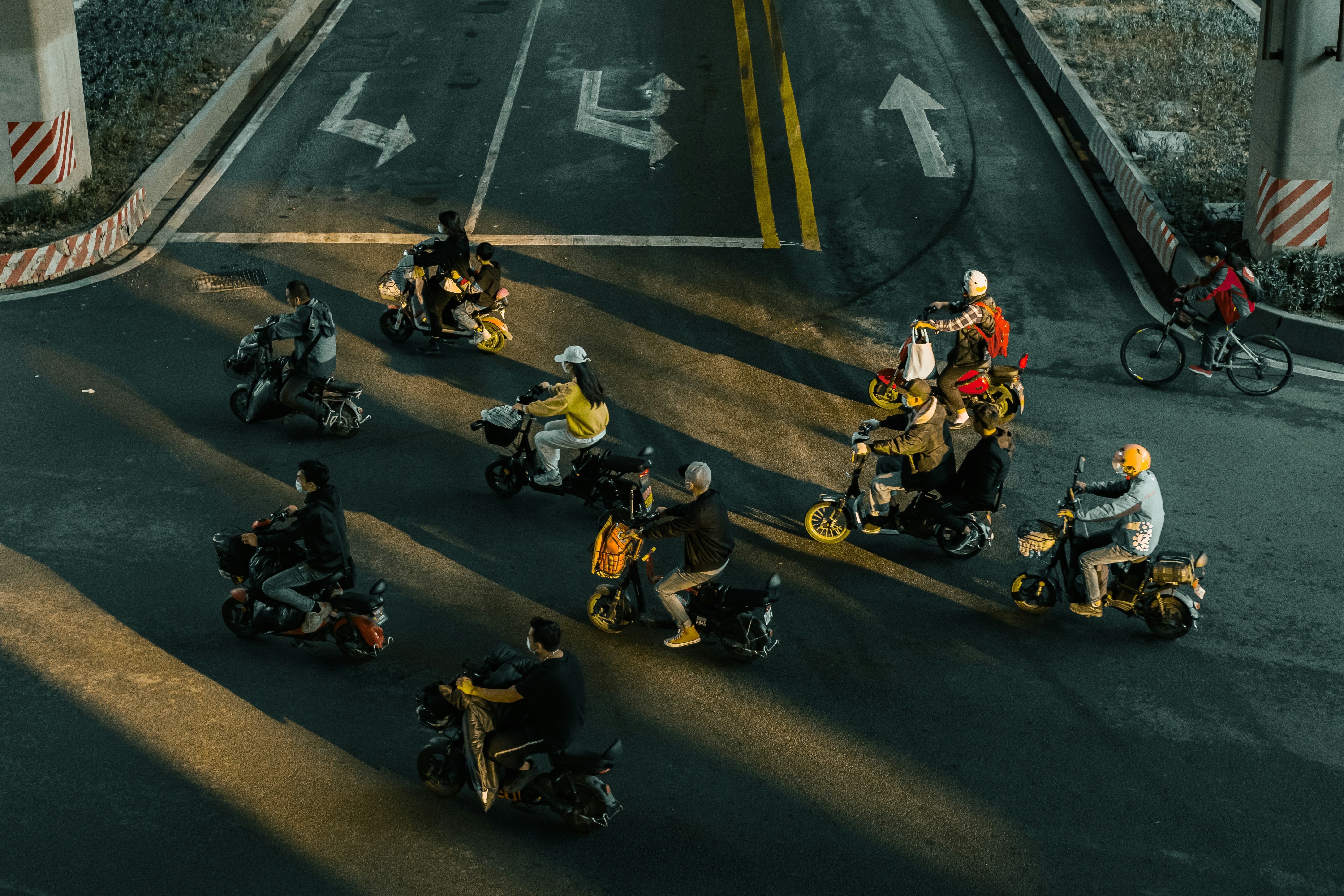 a group of people riding motorcycles down a street