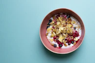 Colorful array of toppings like fresh berries, nuts, and honey drizzled over frozen yogurt.